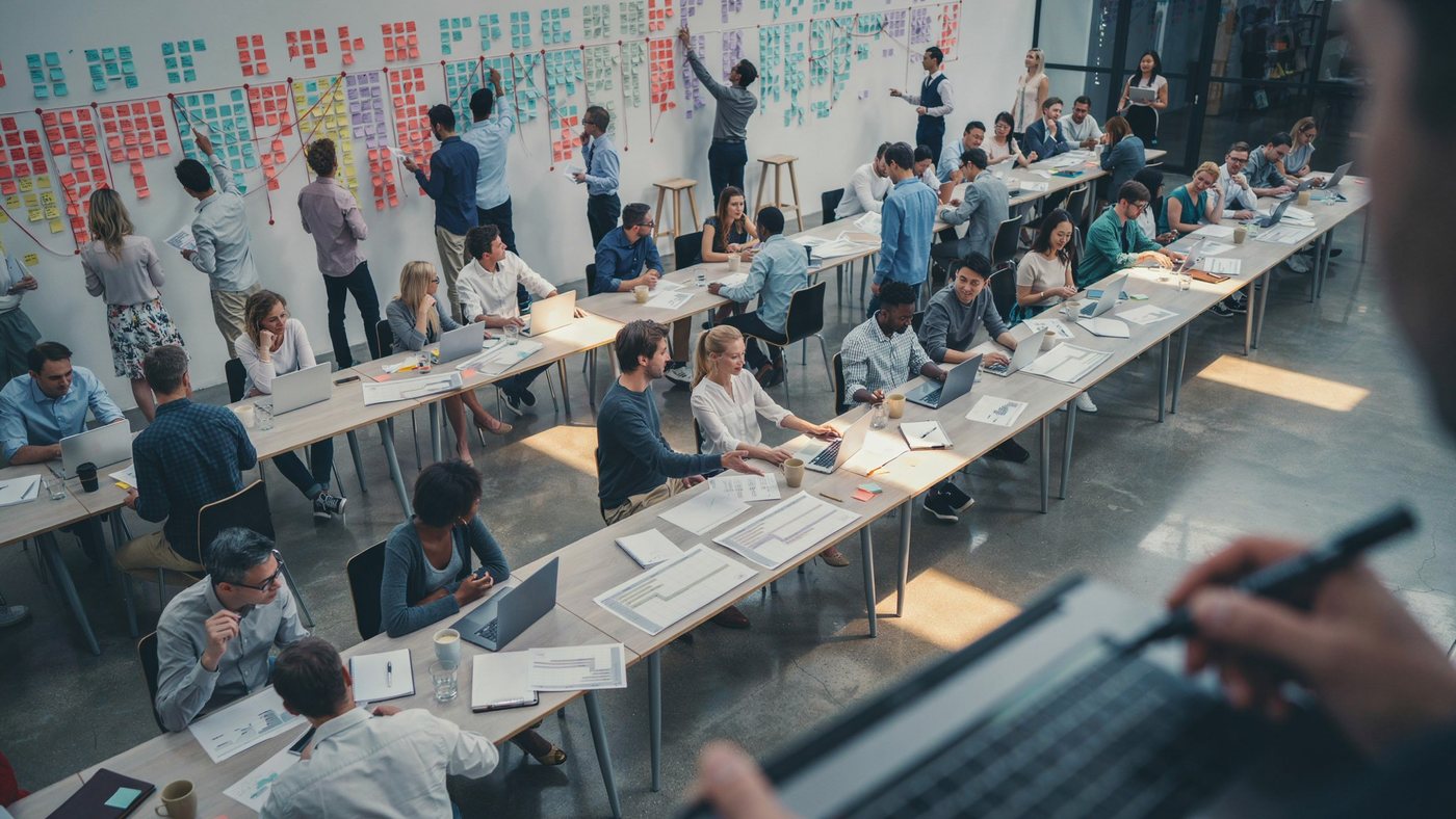 A programme increment planning room with a wall-length board of colour-coded sticky notes